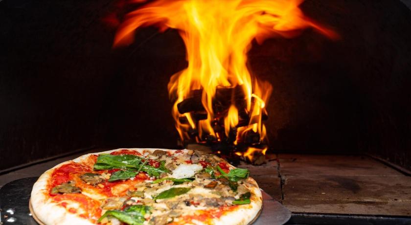 a pizza is being cooked in an oven, Falls River Luxury Accommodation in Deloraine