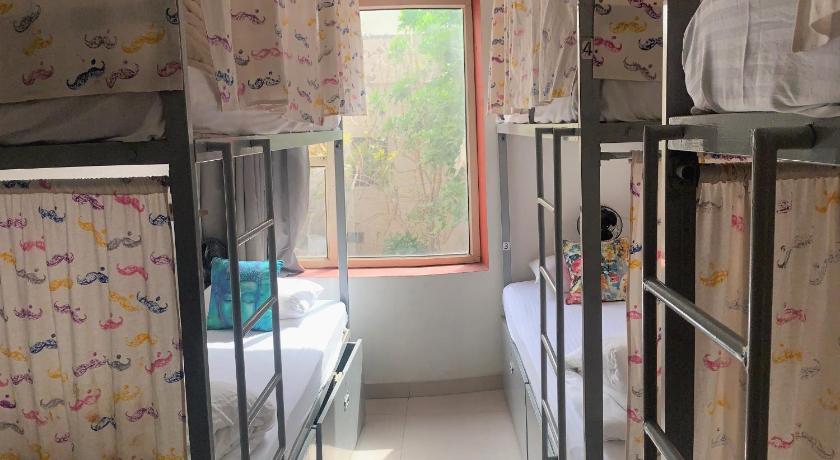 a bedroom with two bunk beds and a window, Moustache Hostel Agra in Agra