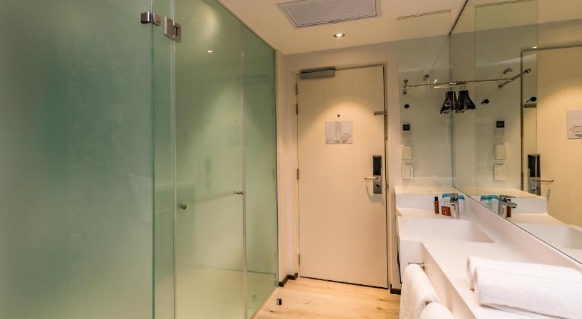 a bathroom with a shower and a sink, Hotel Sky, Sandton in Johannesburg