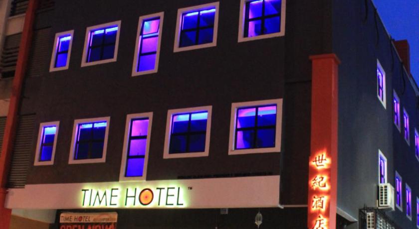 a large building with a neon sign on the side of it, Time Hotel Sunway in Kuala Lumpur