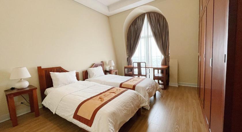 a hotel room with a bed, chair, and nightstand, Pacific Place Serviced Apartment in Hanoi