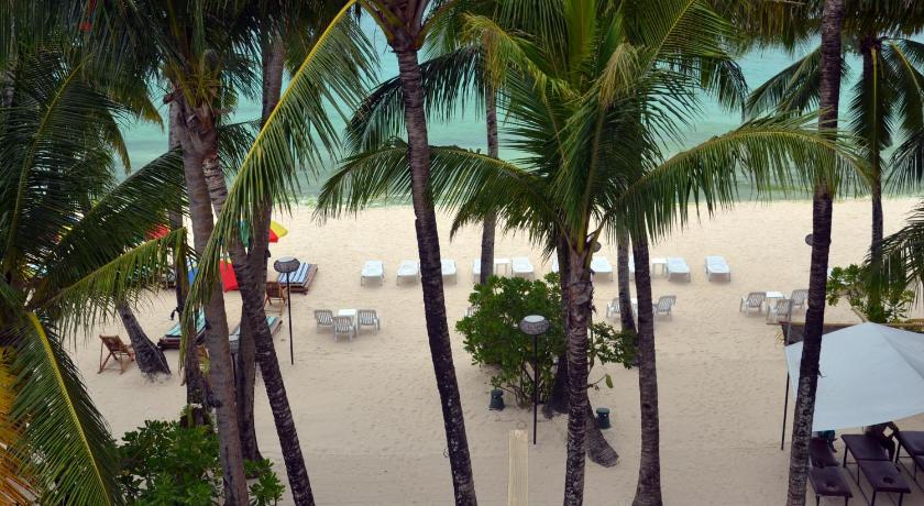 a beach filled with palm trees and palm trees, Signature Boracay South Beach (Formerly Hey Jude South Beach) in Boracay Island