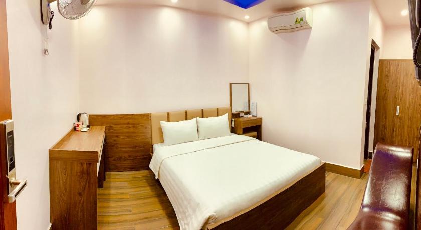 a bedroom with a white bed and white walls, MV HOTEL in Haiphong