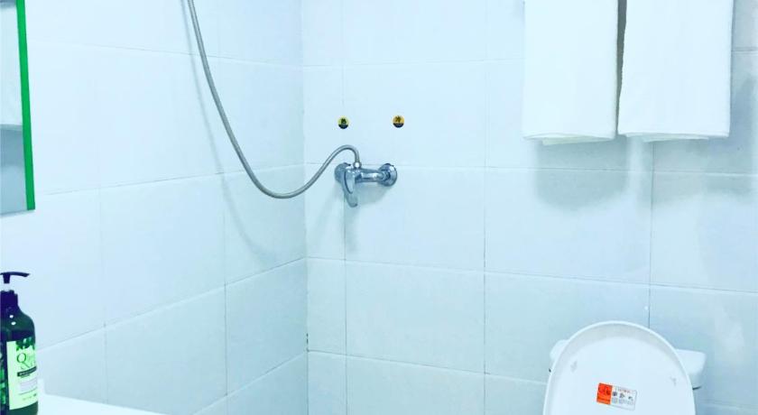 a white toilet sitting next to a white sink, Tongfu inn in Zhangjiajie