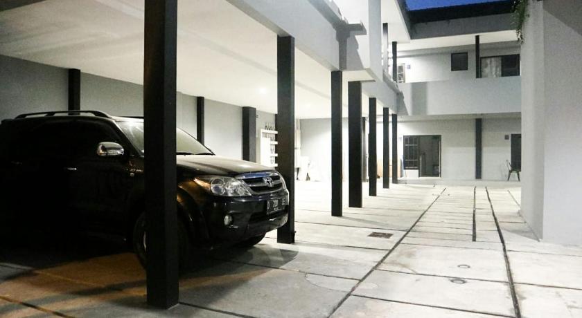 a car parked in a parking lot next to a building, DPARAGON KUSUMANEGARA in Yogyakarta