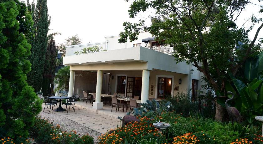 a patio area with a patio table and chairs, Highgrove Guesthouse in Johannesburg