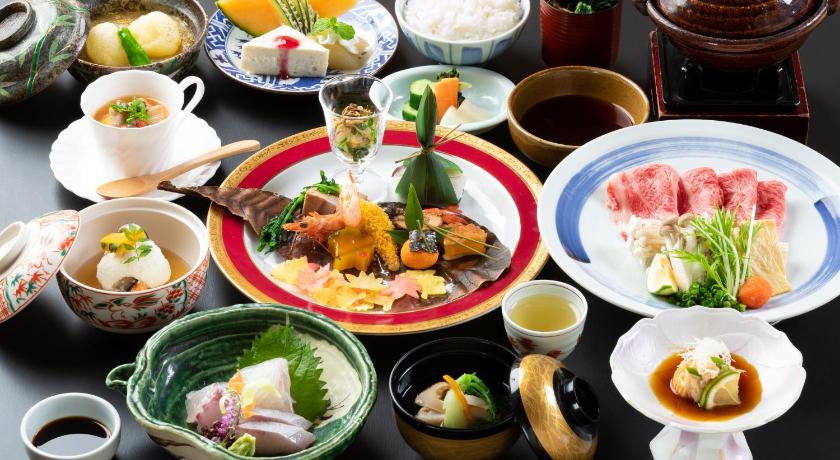 a table topped with plates of food, Ryotei Tanokura Ryokan in Yufu