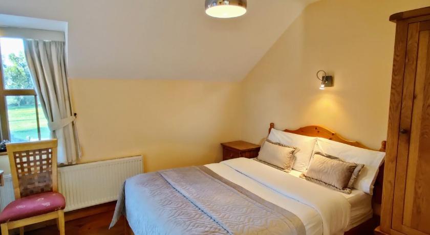 a bedroom with a white bed and white walls, Moynure House Boutique B&B in Athlone