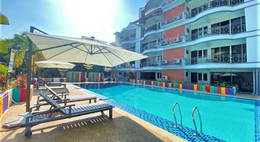 a hotel room with a pool and chairs, Perdana Serviced Apartment Resorts in Langkawi