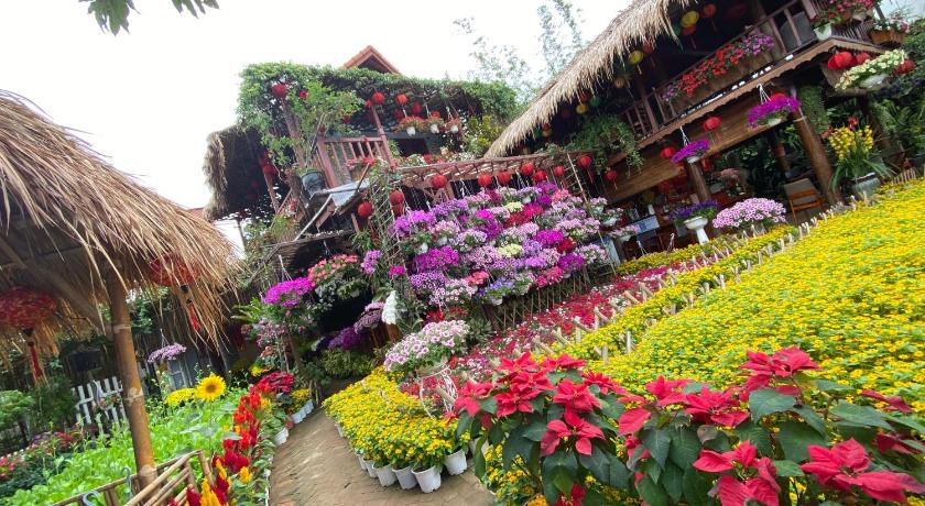 a flower garden filled with lots of flowers, Khamy Riverside Resort in Hoi An