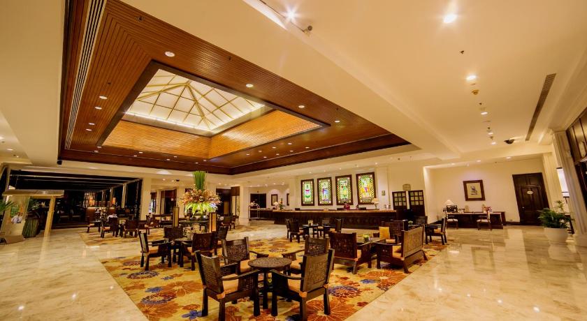 a living room filled with furniture and a large window, Waterfront Airport Hotel and Casino Mactan in Cebu