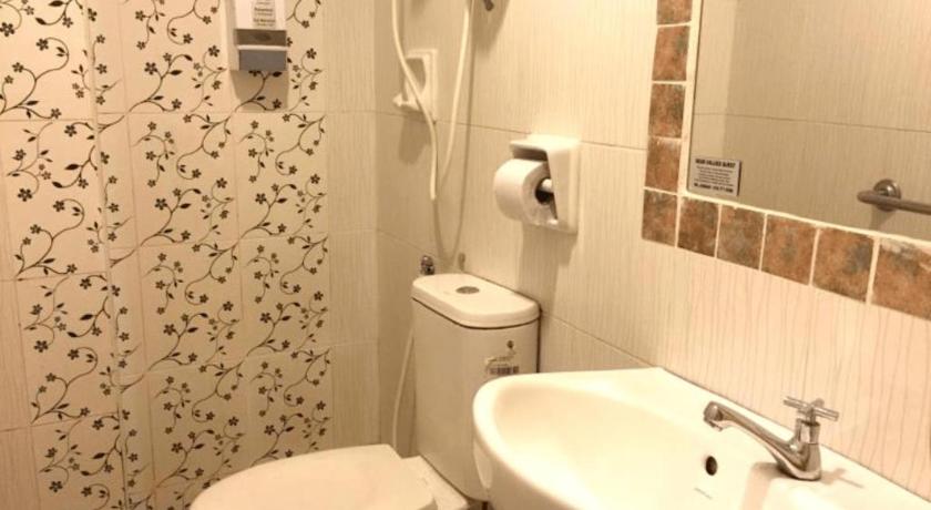 a white toilet sitting next to a sink in a bathroom, SUN INNS MERU RAYA in Ipoh