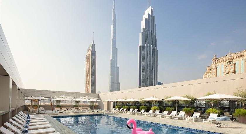 a large swimming pool in a large building, Rove Downtown in Dubai