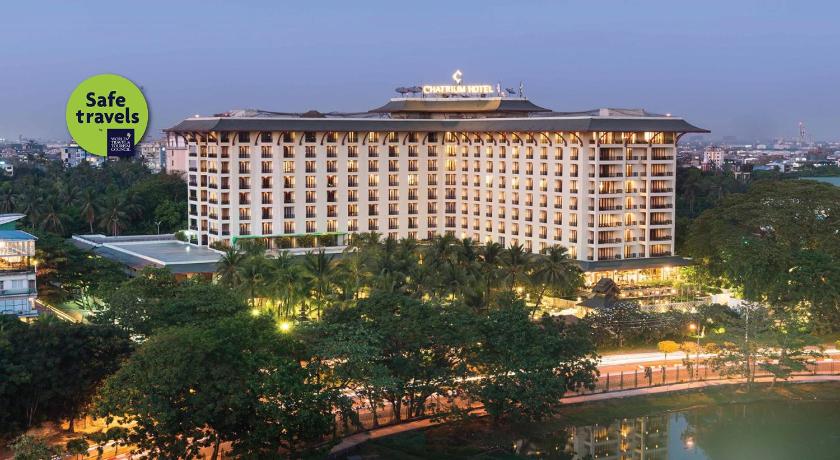 a large building with a clock on top of it, Chatrium Hotel Royal Lake Yangon in Yangon