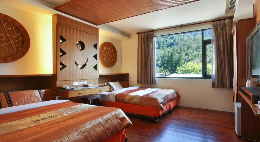 a hotel room with a bed, desk and a window, Sun Moon Lake Itathao Motel in Nantou