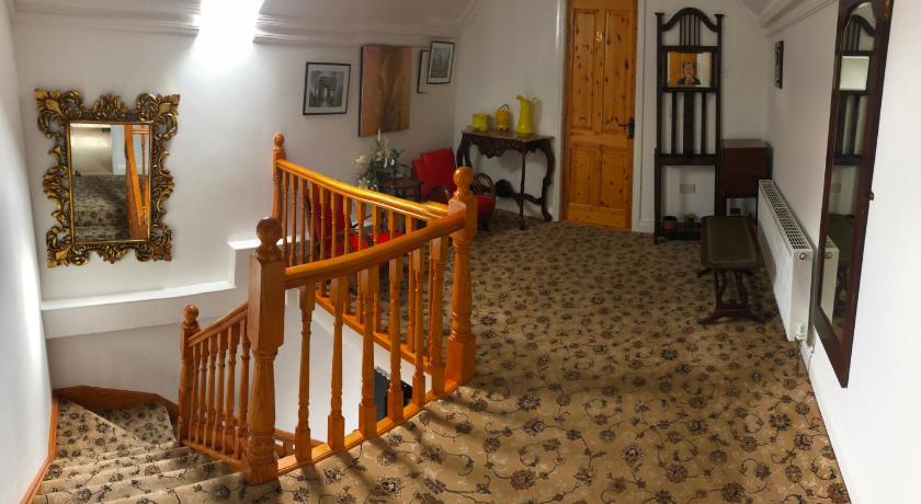 a person is standing in a room with a staircase, Rockville House B&B in Cashel