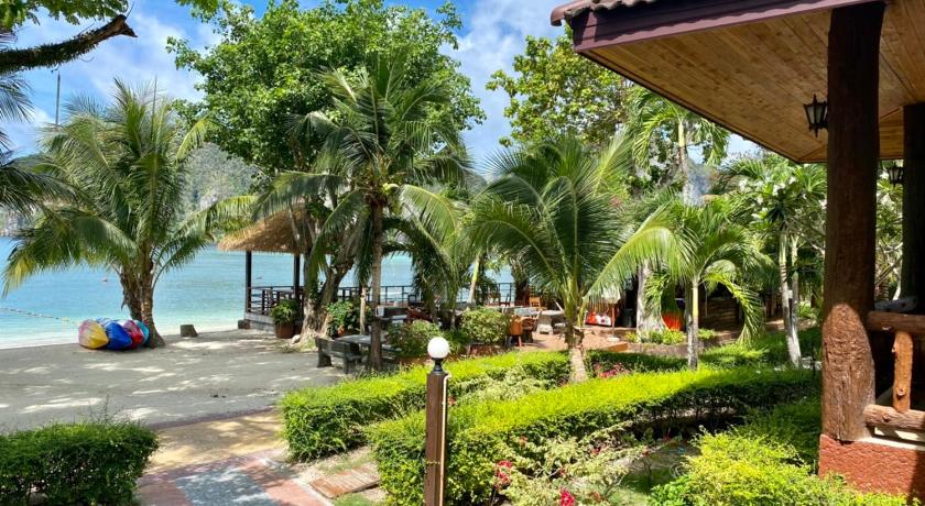 a beach with palm trees and palm trees, Phi Phi Villa Resort (SHA Extra Plus) in Ko Phi Phi