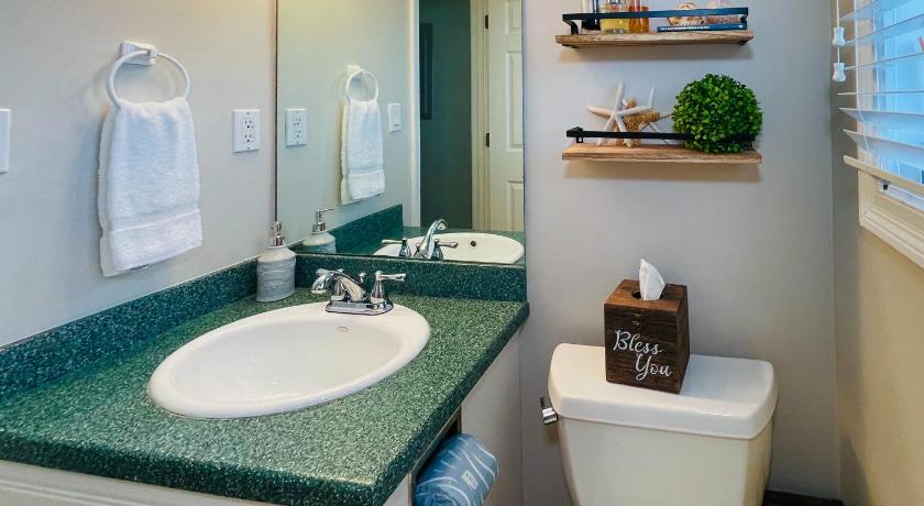 a bathroom with a sink, toilet, and mirror, Santa Rosa Dunes in Pensacola Beach (FL)