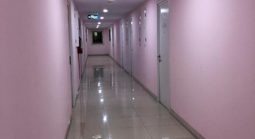 a room with a white wall and a blue floor, 2BR Green Pramuka Apartment in Jakarta