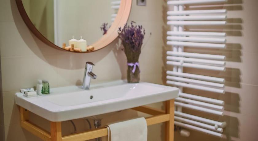 a bathroom with a sink and a mirror, Imola Udvarhaz Hotel in Eger