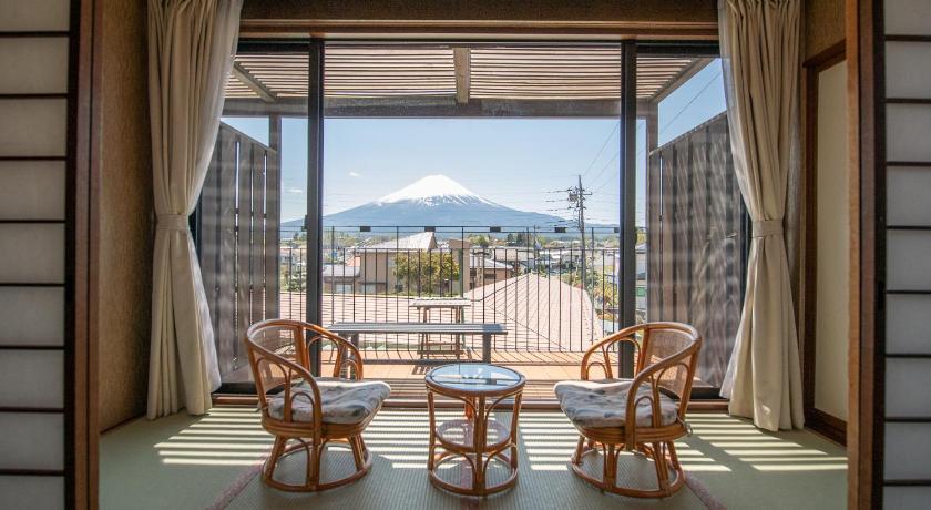 a dining room table with two chairs and a window, Fuji no Yado Ohashi Hotel in Fujikawaguchiko