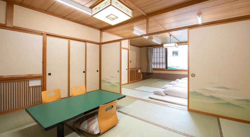 an empty room with a table and chairs, Fuji no Yado Ohashi Hotel in Fujikawaguchiko