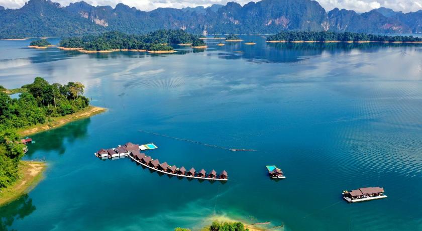 a large body of water with a bridge over it, 500 Rai Floating Resort                                                                           in Surat Thani