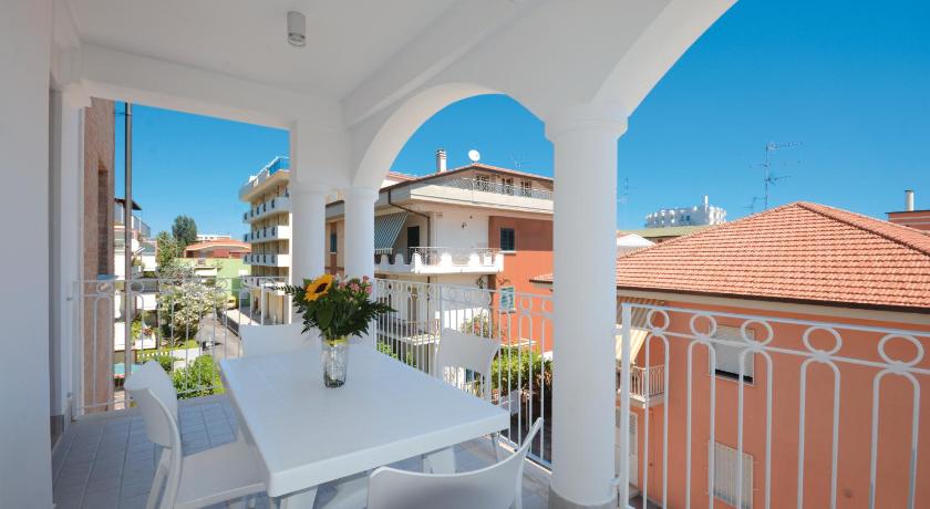 a dining room table with a balcony overlooking the ocean, Residence Hotel Alba Palace in Alba Adriatica