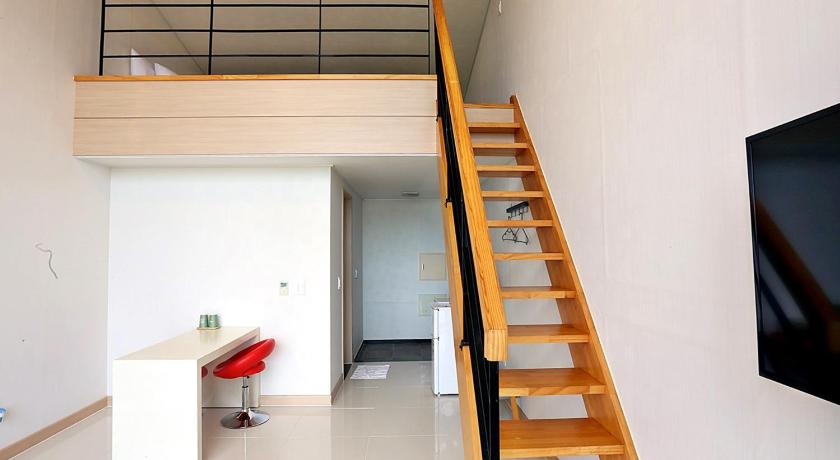a room with stairs leading up to a staircase, J Raum Boutique Pension in Jeju
