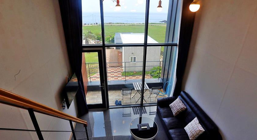 a living room filled with furniture and a window, J Raum Boutique Pension in Jeju