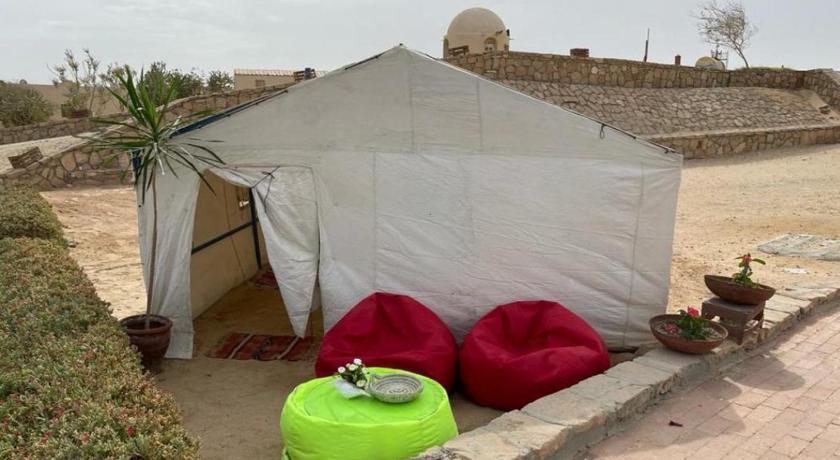 a tent with a blanket on top of it, Sharm El Naga Resort and Diving Center in Hurghada