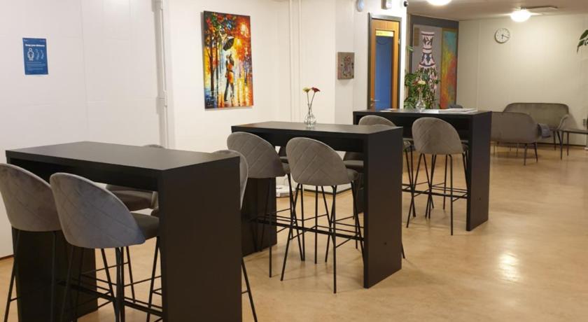 a room with a table, chairs, and a refrigerator, Aarhus Hostel in Hasselager