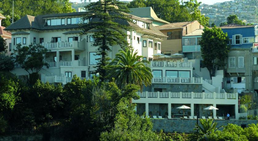 a large building with trees and houses, Hotel Casa Higueras in Valparaiso