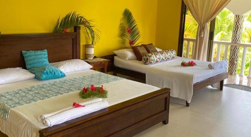 a bedroom with a bed and a dresser, Linsen Self Catering Apartments in Seychelles Islands