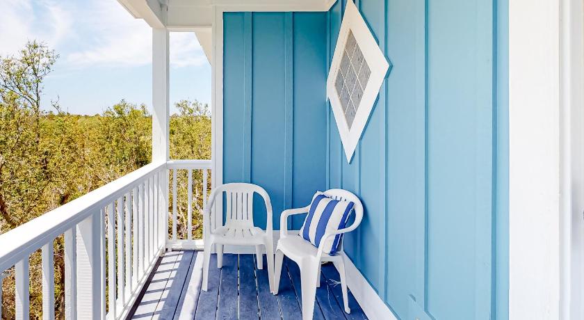 a white chair sitting in front of a patio door, Big Blue Beach House, Gulf Shores Plantation #2A in Gulf Shores (AL)
