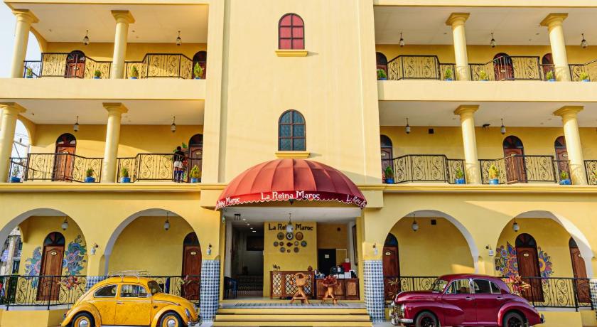 a large building with a clock on the front of it, La Reina Maroc Hotel in Khao Yai