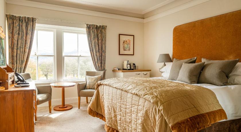 a bedroom with a large bed and a large window, The Lovat, Loch Ness in Fort Augustus