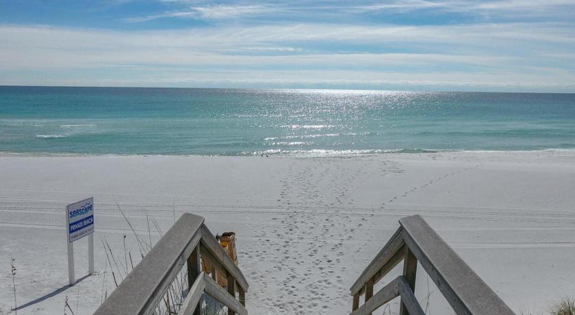 a beach with a row of wooden boards on it, Ariel Dunes by Seascape Resort in Destin (FL)