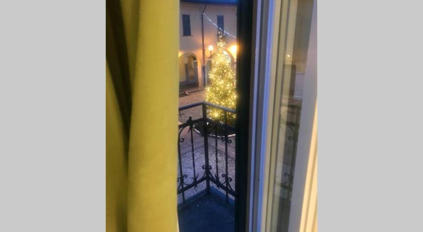 a view through a window of a room with a balcony, Green Appartamenti i Portici nel centro storico in Melzo
