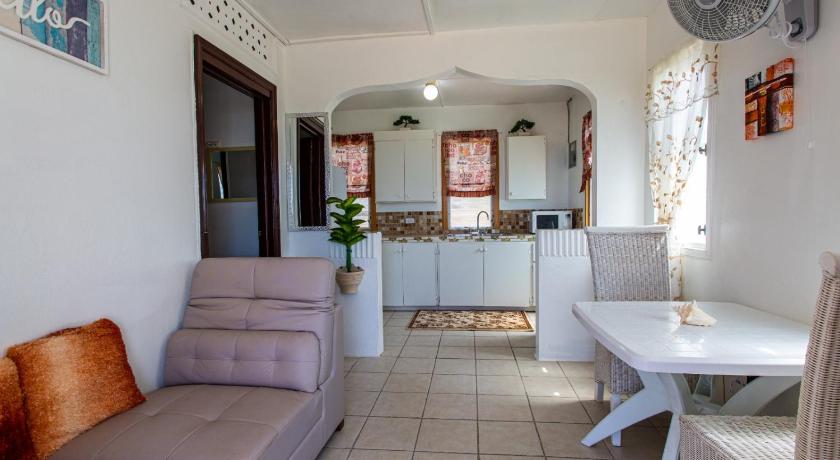 a living room with a couch and a table, Moonlight Cottage in Anguilla