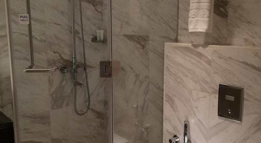 a bathroom with a toilet, sink, and shower stall, InnB Park Hotel in Kuala Lumpur