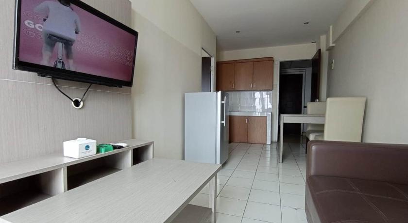 a living room with a tv and a refrigerator, X-press bedroom Mutiara-Bekasi in Bekasi