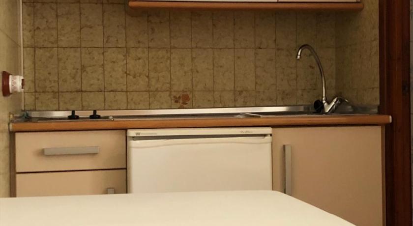 a kitchen with a microwave and a dishwasher, Apartamentos Casanova in Nerja