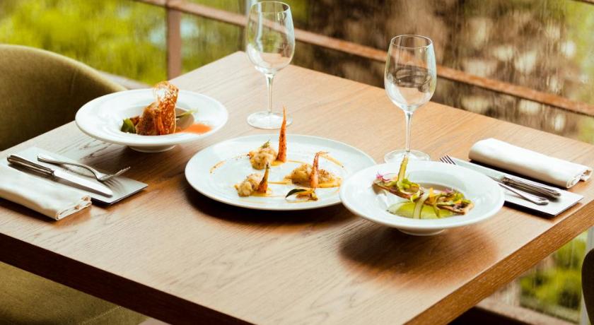 a table with a plate of food and a glass of wine, Hotel La Culla Del Lago in Castel Gandolfo