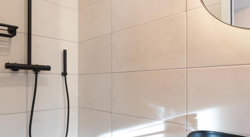 a bath room with a shower and a sink, Boutique Hotel Rijks I Kloeg Collection in Goes