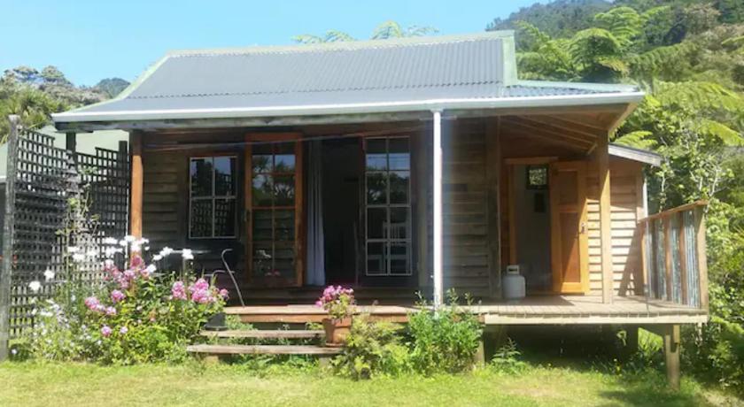 a house with a porch and a balcony, The Innlet, Country Apartments and Cottages in Golden Bay