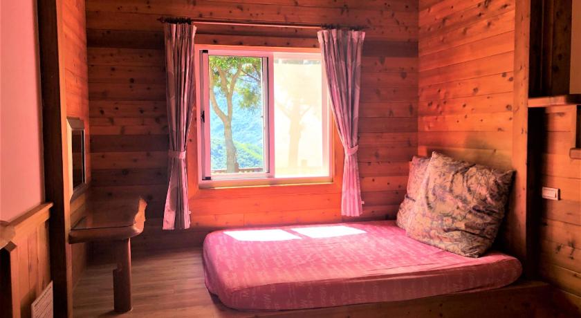 a bedroom with a bed and a window, Aurora villa in Nantou