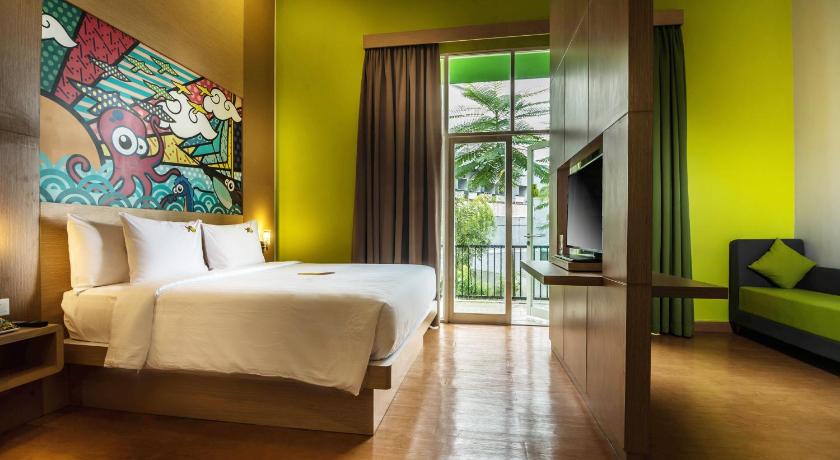 a bedroom with a large bed and a large window, MaxOneHotels.com @ Resort Makassar in Makassar