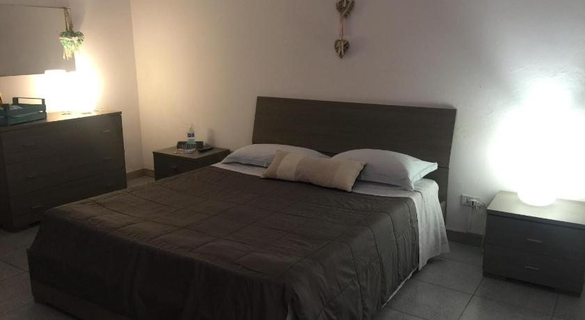 a bedroom with a bed and a lamp, B&B Il Tulipano in Taranto