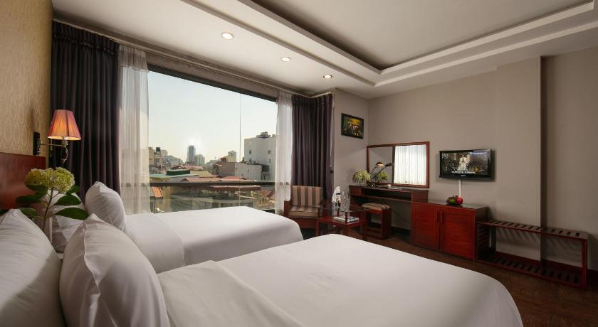 a hotel room with two beds and a large window, Sen Hotel in Hanoi